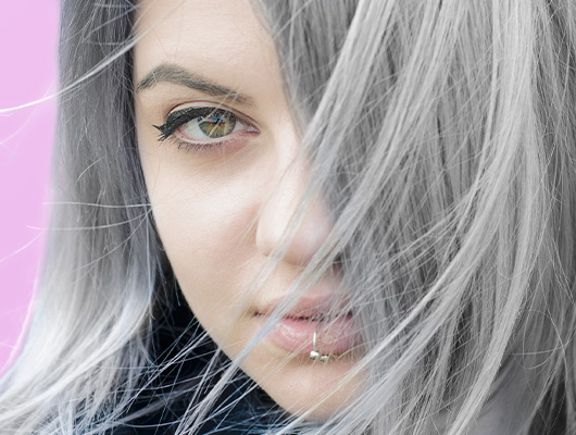 Woman with straight styled Titanium colored hair
