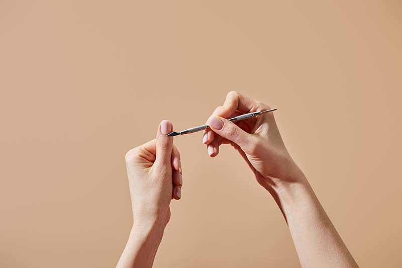 picture of model using manicure tools