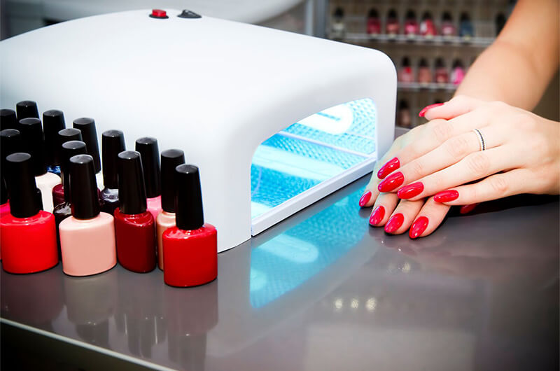 dark red gel nails on table.
