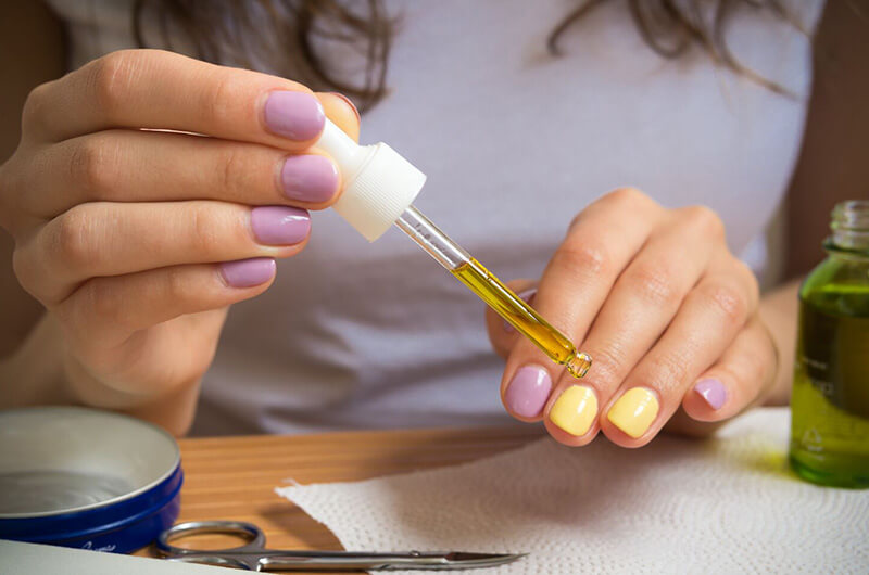 nail dropper serum on nails.