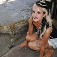 Image of Emily Boulin posing with a hyena