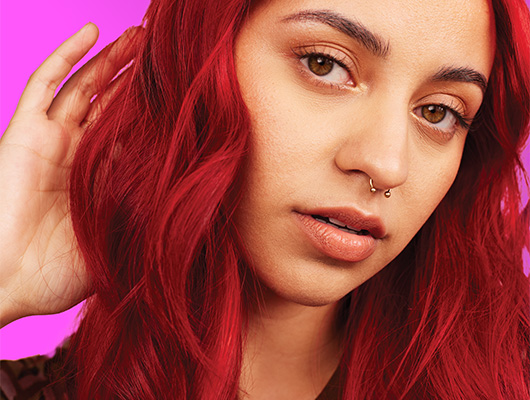 Woman with wavy styled Garnet Red colored hair