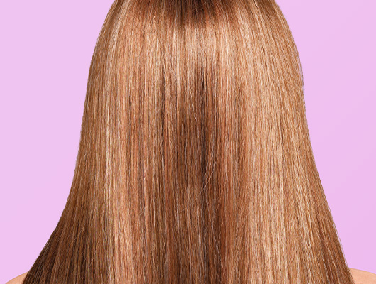 Woman with straight styled Honey Brown colored hair
