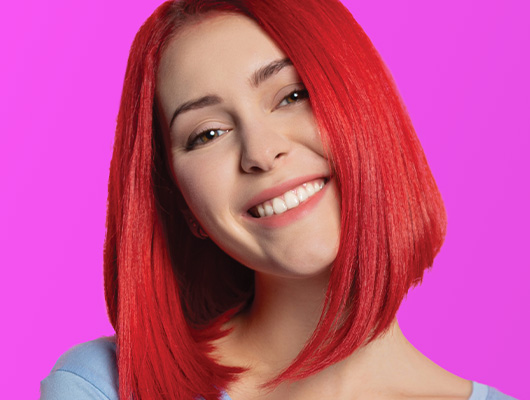 Woman with short straight styled Red velvet colored hair