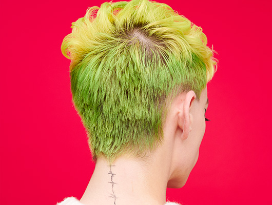 Woman with short styled Holiday Green colored hair