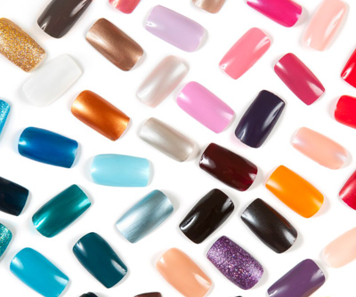 all different colors of acrylic nails layed out on white background