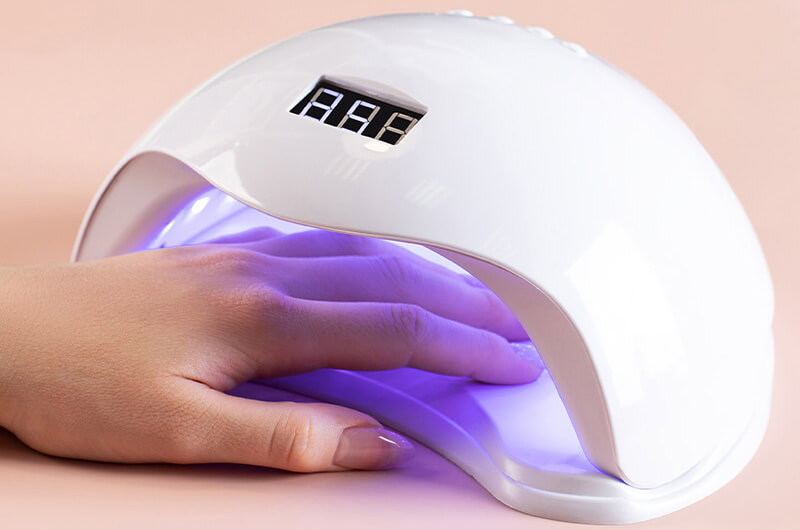image of using hand dryer for nails.