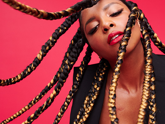 Woman with braided styled pumpkin spice colored hair